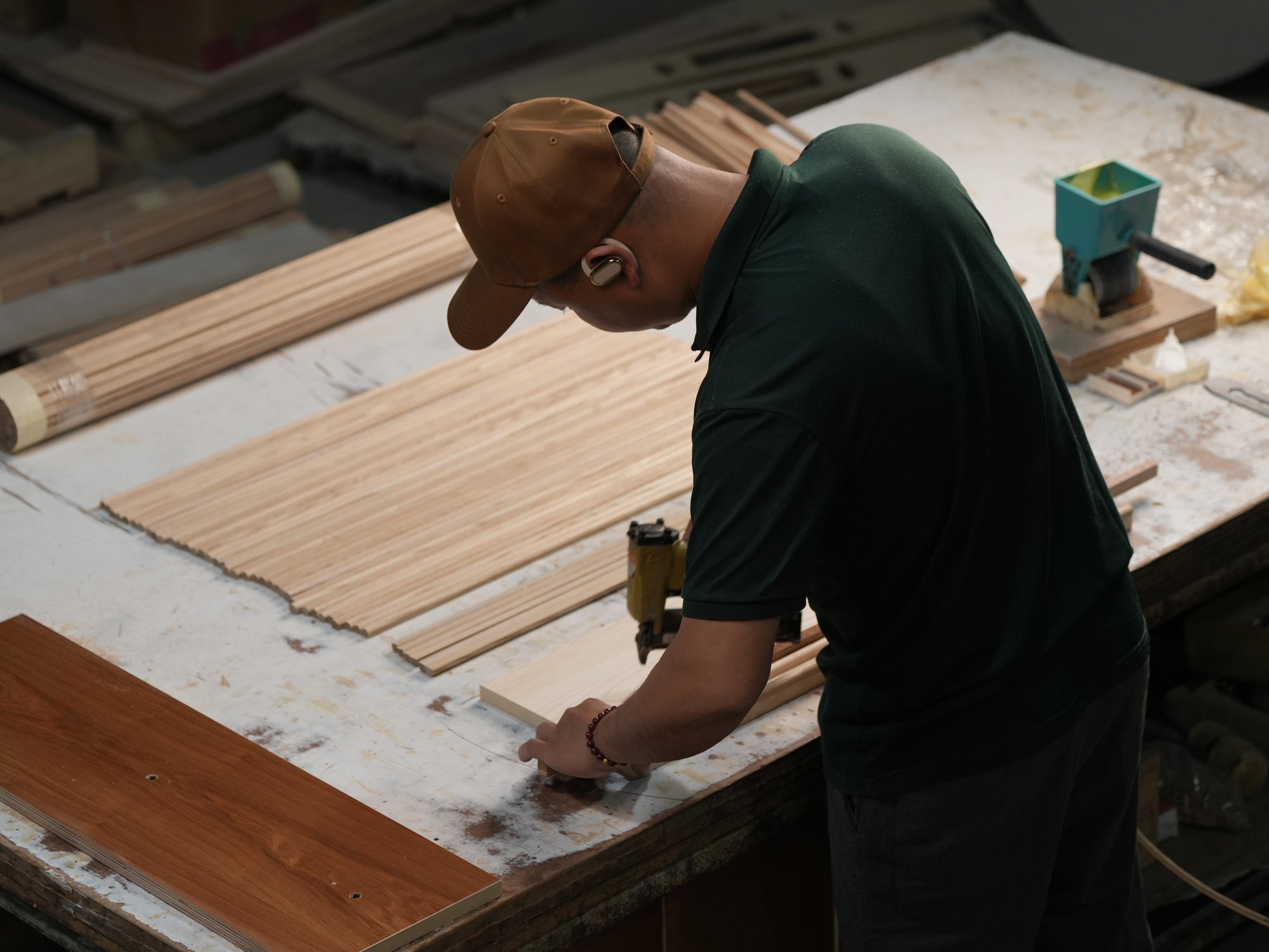 Person working with wood on a table saw in a workshop